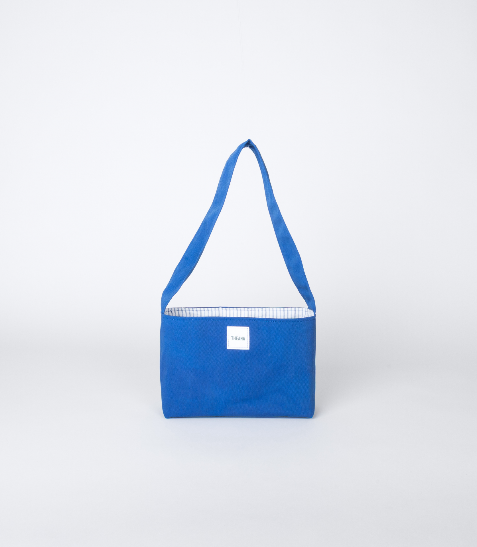 mini sac bleu électrique en tissu avec doublure blanche rayée bleue et bouton aimanté – marque Theana